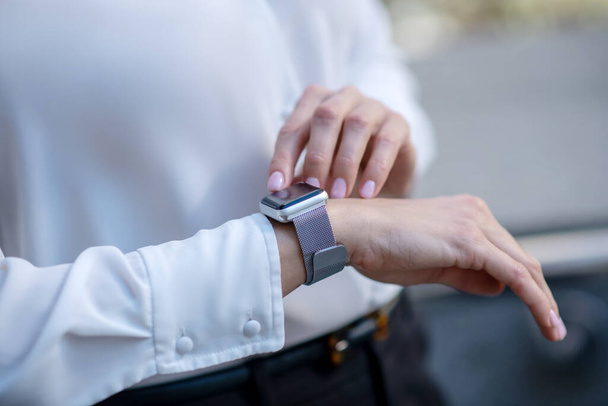 Close up picture of a woman touching a smartwatch - Fotó, kép