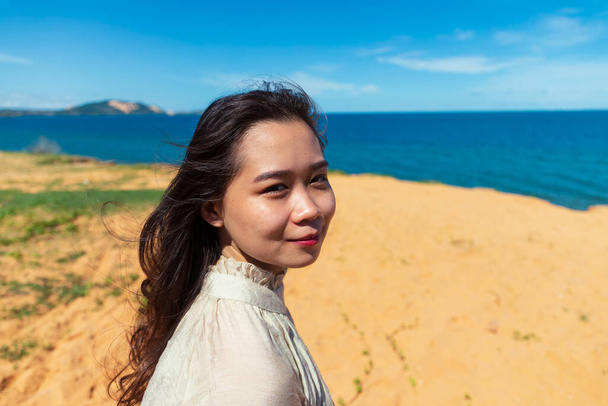 A closeup shot of a young Asian lady on the beach - Foto, immagini