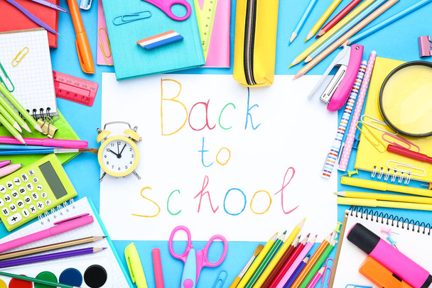 Text Back to School with different school supplies on blue background - Zdjęcie, obraz