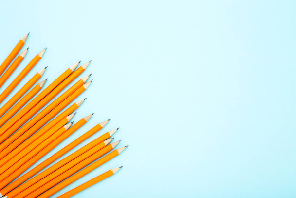 Yellow pencils on blue background - Foto, afbeelding