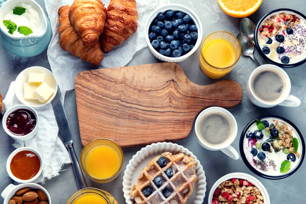 Healthy breakfast with freshly baked croissants on gray background.  Top view, flat lay, copy space. - Фото, изображение