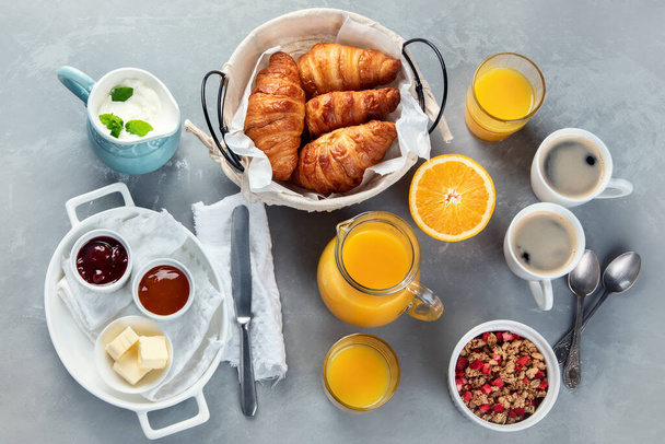Healthy breakfast with freshly baked croissants on gray background.  Top view, flat lay - Fotografie, Obrázek