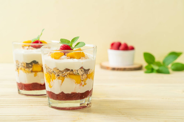 homemade fresh mango and fresh raspberry with yogurt and granola - healthy food style - Foto, Imagem