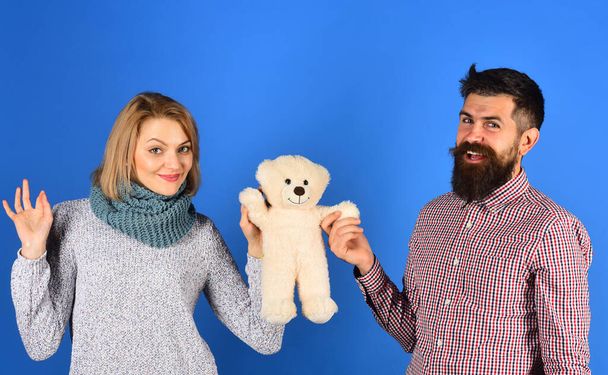 Girl and man with cheerful faces play with soft toy. - Fotó, kép