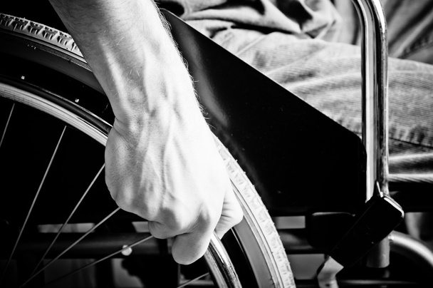 Close-up of male hand on wheel of wheelchair - blac and white - Fotografie, Obrázek