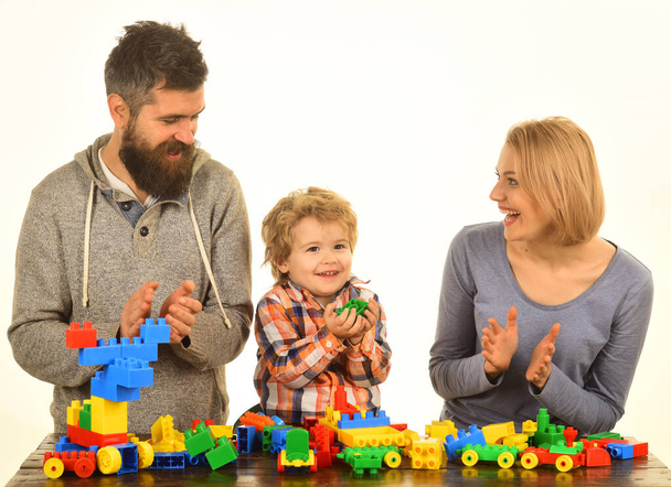 Family with cheerful faces build out of colored construction blocks - Foto, Imagen