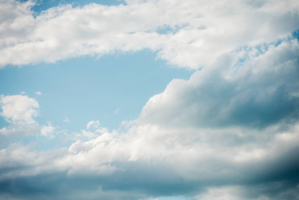Blue sky with floating white clouds. The background - Zdjęcie, obraz