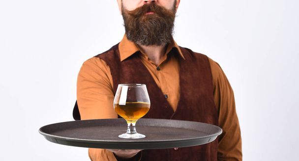 Waiter with whiskey or scotch on tray. - 写真・画像