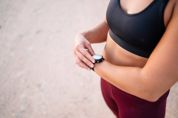Athletic woman with smartwatch at street - Foto, Imagem