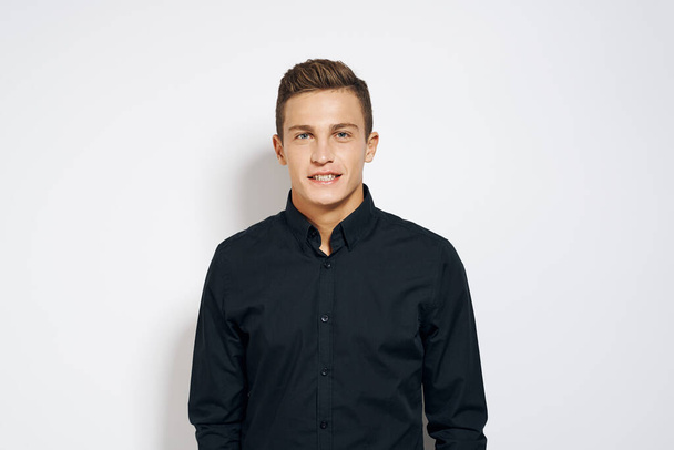 Man in black shirt lifestyle emotions modern style cropped view light background - Foto, Imagen