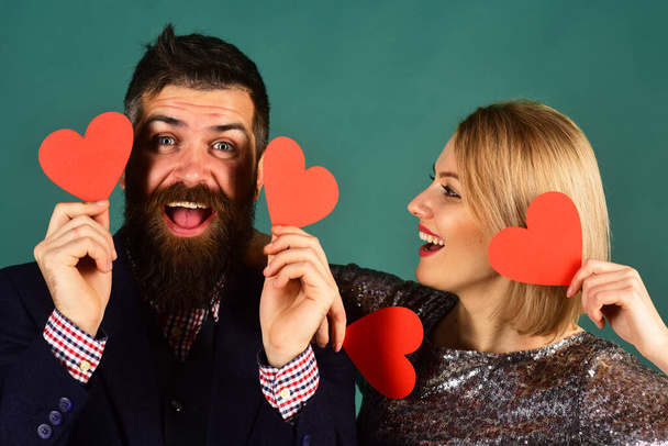 Girl and man with cheerful faces play with paper hearts - Fotoğraf, Görsel