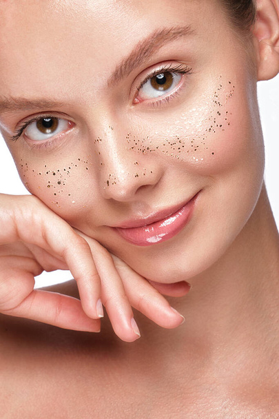 Beautiful young girl with a light natural make-up, glitter freckles and perfect skin. Beauty face. - Фото, изображение