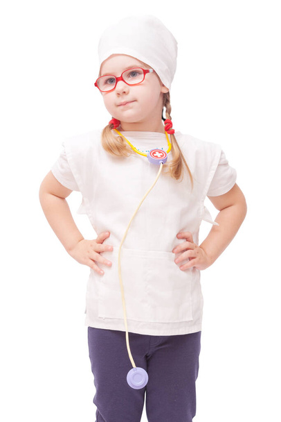 young girl with glasses plays in the doctor as a mom - Fotoğraf, Görsel