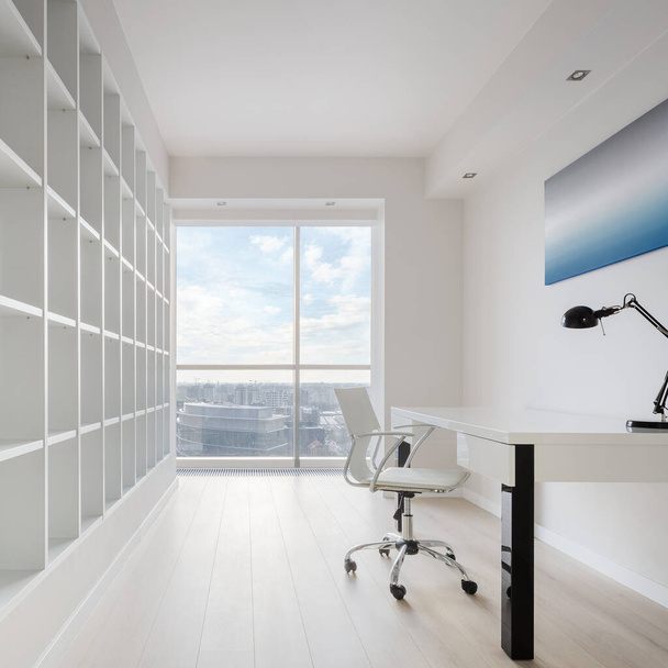 Simple home office room in white with big bookcase, desk with chair and with nice city view - Foto, Imagen