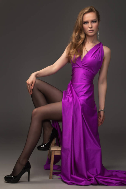 sexy girl in evening dress posing over dark background - Фото, изображение