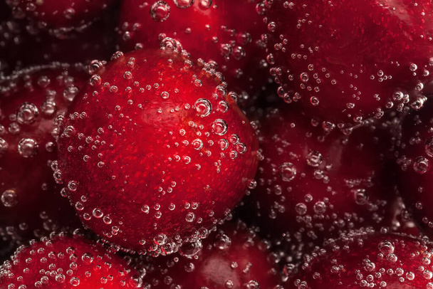 cherry in water with bubbles. background - Zdjęcie, obraz
