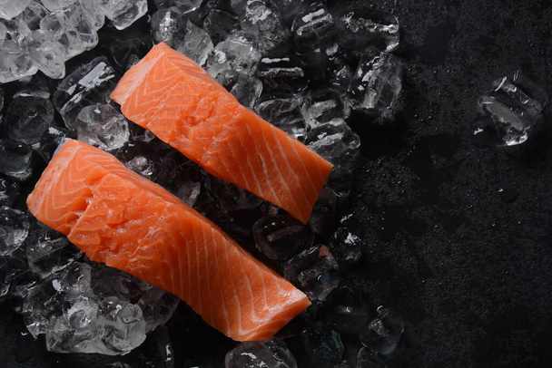 Raw salmon steaks on ice background  - Foto, immagini