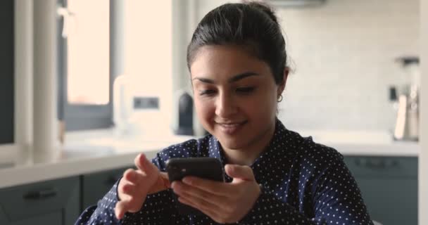 Indian woman use smartphone smiles enjoy distant chat with boyfriend - Кадри, відео