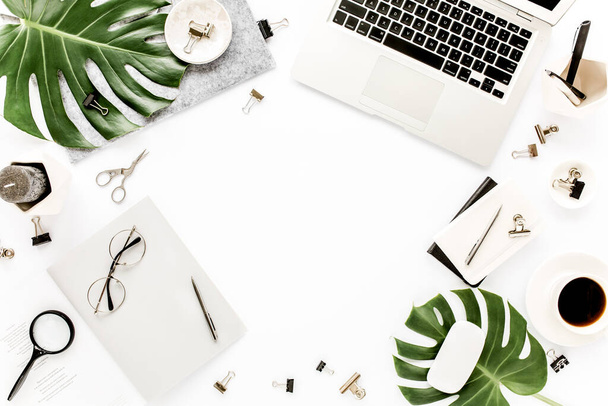 Home office workspace mockup with laptop, tropical leaves Monstera, clipboard, notebook and accessories on white background. Flat lay, top view - Foto, immagini
