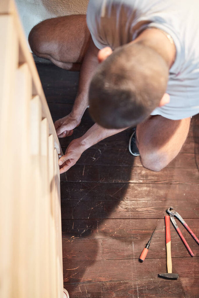 Carpenter hobbyist assembling wooden boards at home / garage. - Foto, Imagen