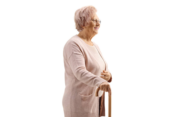 Elderly lady with a cane standing isolated on white background - Foto, imagen