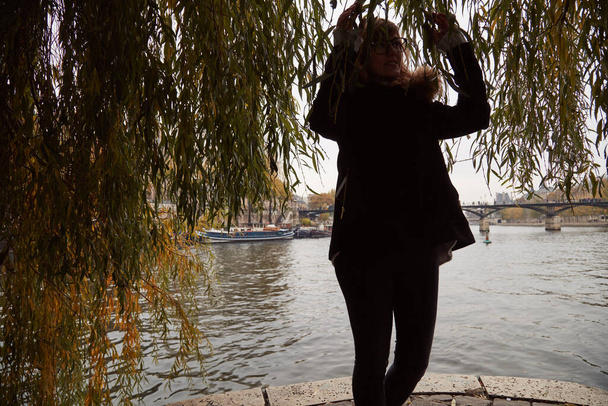 Young woman enjoying time on Pont Neuf, heart of Paris, France. - Foto, Imagen
