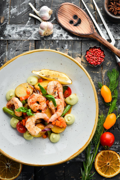 Baked shrimp with potatoes and vegetables. Top view. Free space for text. - Foto, immagini