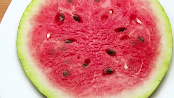 Red watermelon rotating on background in 4K ProRes 422. Refreshing and healthy tasty juicy fruit. Closeup flat-lay view. - Footage, Video