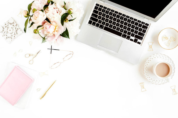 Flat lay womens office desk. Female workspace with laptop, pink peonies bouquet, accessories on white background. Top view feminine background. - Foto, Imagem