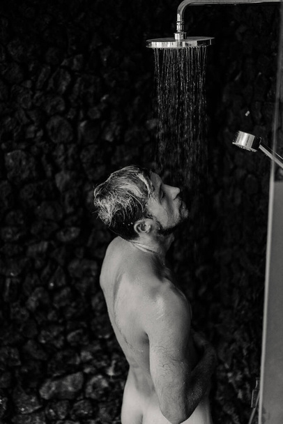 Man taking a shower washing hair with shampoo product under wate - Φωτογραφία, εικόνα