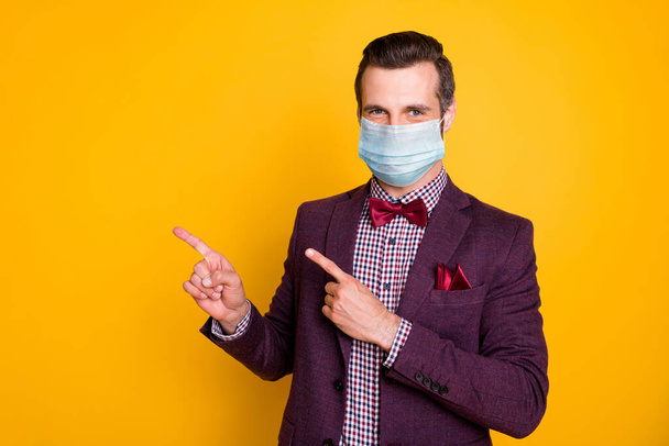 Portrait of his he nice attractive healthy guy wearing gauze safety mask mers cov disease prevention showing copy space solution isolated bright vivid shine vibrant yellow color background - Foto, Bild