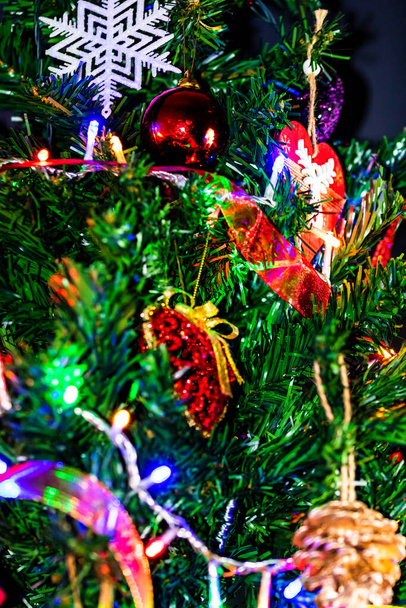 Christmas hanging decorations on fir tree. Decorated Christmas tree. Fir branch with Christmas baubles decorations. - Φωτογραφία, εικόνα