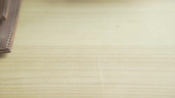 Lähikuva laukaus mies käsi laittaa hopeaa pallo kynä kynä haltijaan vaaleanruskea nahka nuotti pad suunnittelija bullet journal - Materiaali, video