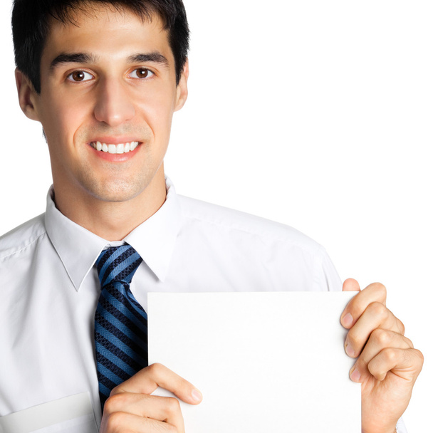 Portrait of happy smiling young businessman showing blank signboard, isolated - Photo, image
