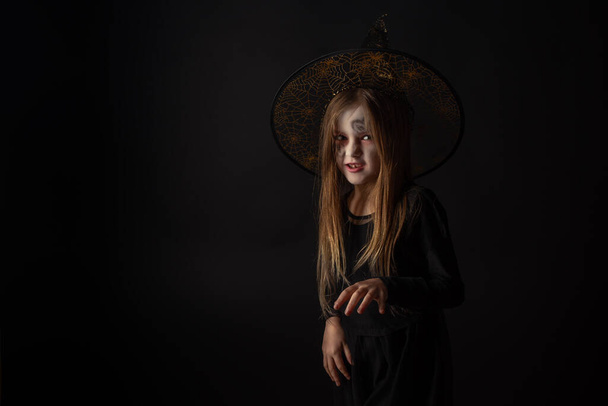 πορτρέτο στούντιο, μικρή μάγισσα σε ένα αποκριάτικο πάρτι - Φωτογραφία, εικόνα