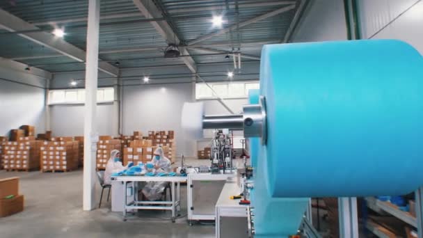 Industrial production of protective medical masks - large coil with blue cloth for medical mask - Footage, Video