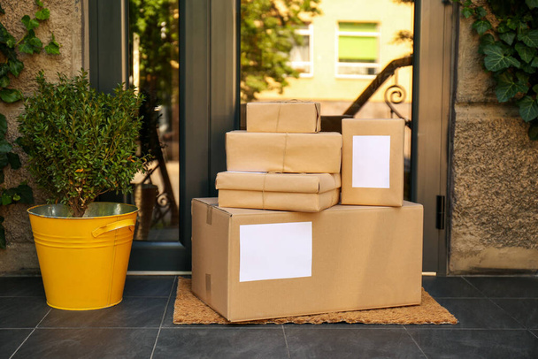 Delivered parcels on door mat near entrance - Photo, Image
