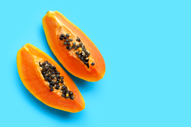 Papaya fruit on blue background. Top view - Фото, зображення