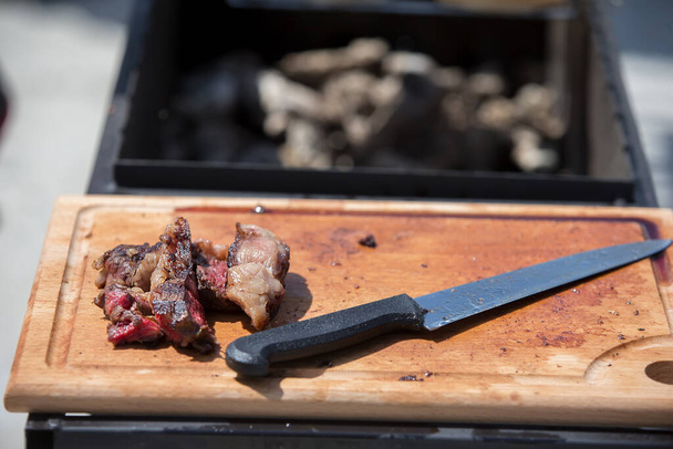 Cutting board, knife and slices of meat. - Photo, Image