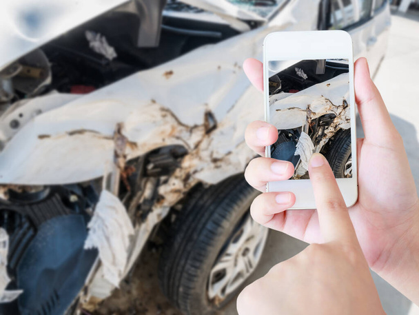 Female using mobile smart phone taking photo of the car crash accident damage for insurance - Foto, Imagem
