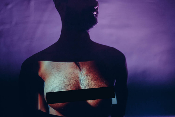 Conceptual image of a tansgender man with woman breast on his chest - Photo, Image