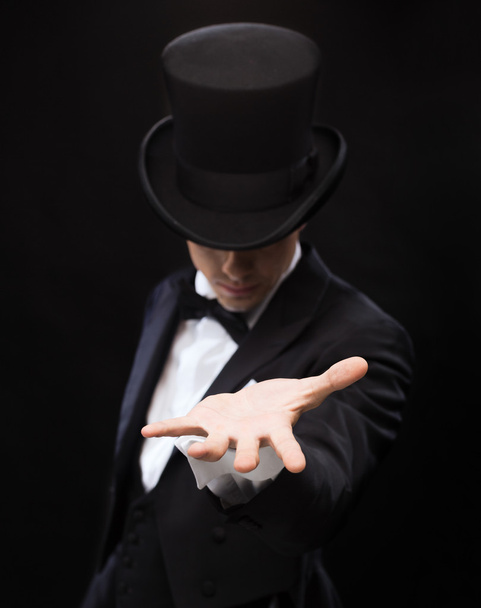 Magician holding something on palm of his hand - Fotoğraf, Görsel