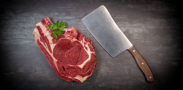 Raw T Bone steak on wooden board prepared to Grill  - Fotó, kép