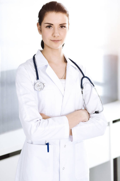 Doctor woman cheerful smiling at camera. Perfect medical service in clinic. Happy future in medicine and healthcare - 写真・画像