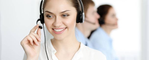 Call center. Diverse customer service operators in headsets at work in office. Business concept - Foto, Bild