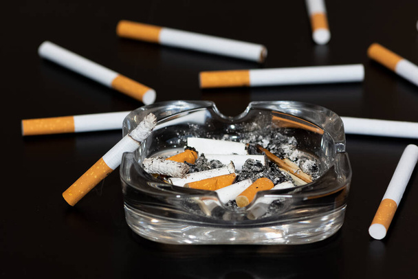 Photos of cigarettes on a black background - Фото, зображення