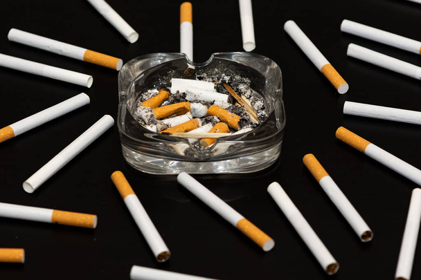 Photos of cigarettes on a black background - Φωτογραφία, εικόνα