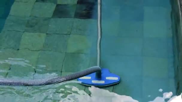 Man cleaning swimming pool with manual underwater vacuum cleaner. Service and technology. - Footage, Video