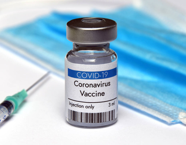 Coronavirus vaccine vial container with syringe and face mask - Photo, Image