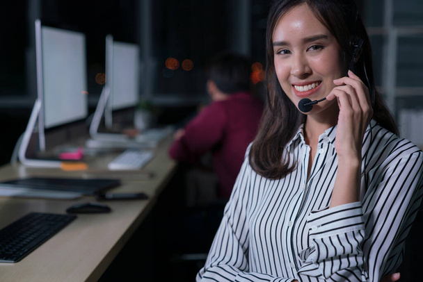 Thai portrait of business person wearing headset working, Young friendly operator woman agent in a call centre. - Foto, imagen